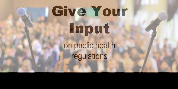 Give Your Input on public health regulations with blurred photograph of crowd and microphones